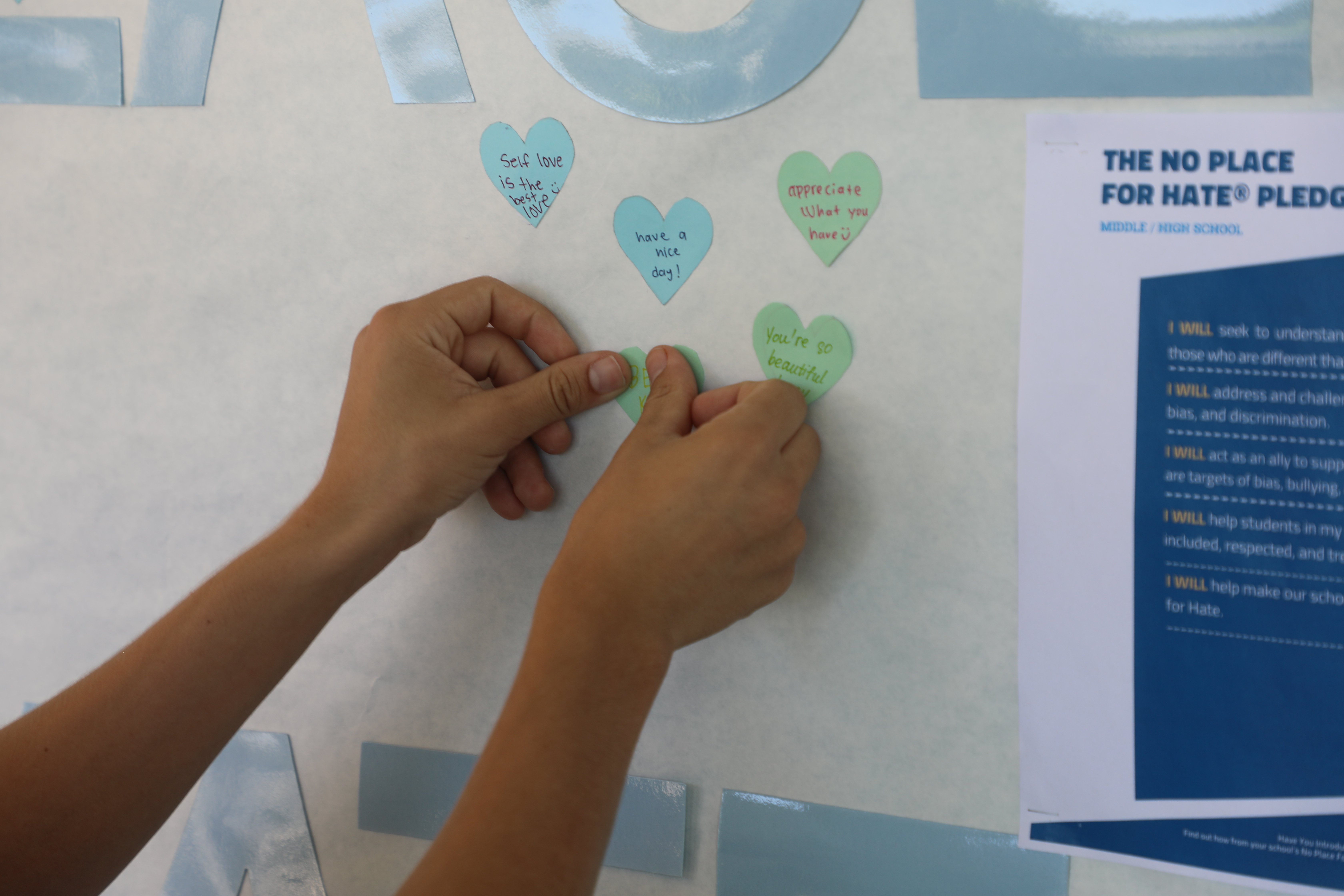 Hare Students Signing a "No Place For Hate Pledge" Banner 